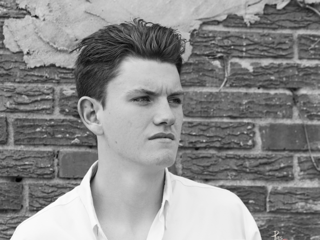 Senior boy; seniors; senior boy; man; black and white; natural light; north tx photographer; pives digital photography; brick background